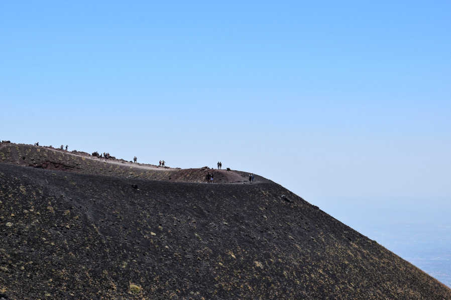 people hiking on the top of Mount Etna