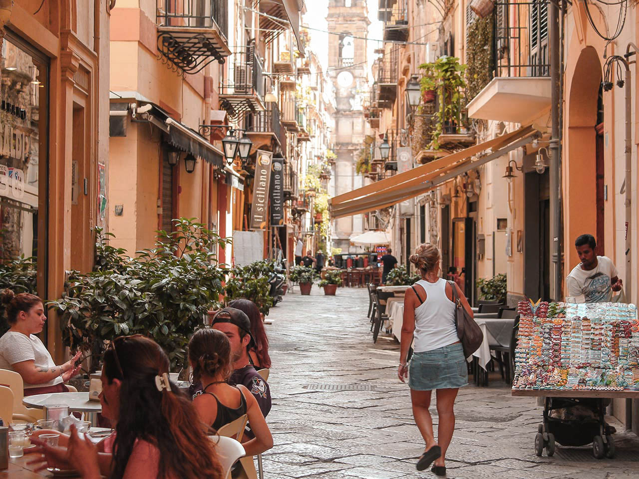 woman walks through the alleys of the historic center of Palermo