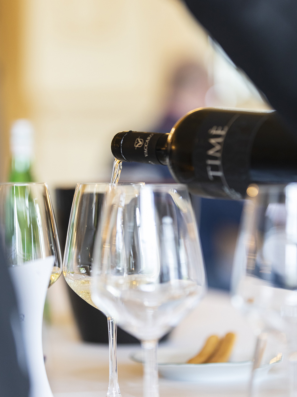 white wine poured into glasses during a tasting