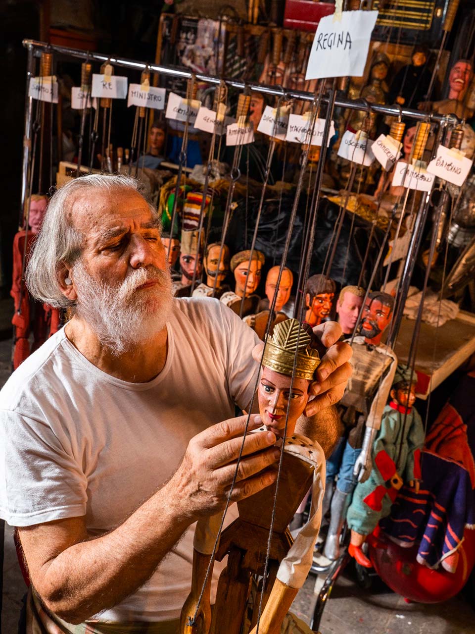 Mimmo Cuticchio, an ancient puppeteer from Palermo, holding a puppet in his hand